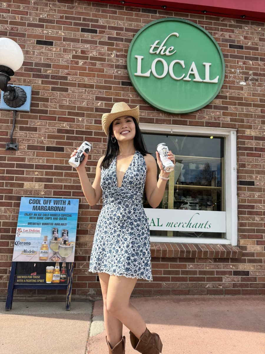 Thy holding two Fizzy Moo cans outside theLOCAL in Parker